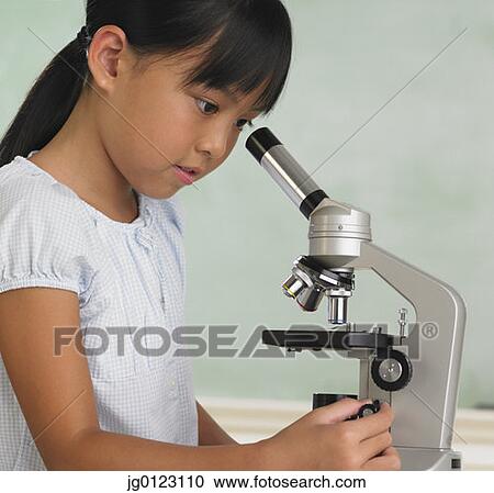 Young Asian girl looking through microscope View Large Photo Image Stock Image - Young Asian girl looking through microscope. Fotosearch