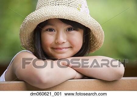 Young Asian girl wearing straw hat and smiling outdoors View Large Photo Image Stock Image - Young Asian girl wearing straw hat and smiling outdoors. Fotosearch