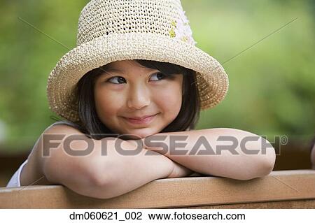 Young Asian girl wearing straw hat and smiling outdoors View Large Photo Image Stock Image - Young Asian girl wearing straw hat and smiling outdoors. Fotosearch