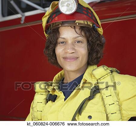 African female firefighter leaning against fire truck View Large Photo Image Stock Photograph - African female firefighter leaning against fire truck. Fotosearch