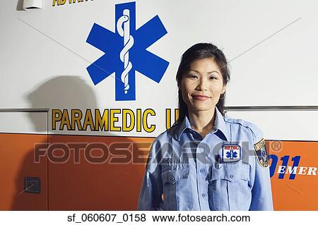 Asian female paramedic standing next to ambulance View Large Photo Image Stock Photo - Asian female paramedic standing next to ambulance. Fotosearch