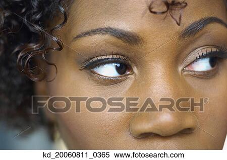 Stock Photography - Close up of African woman looking sideways. Fotosearch