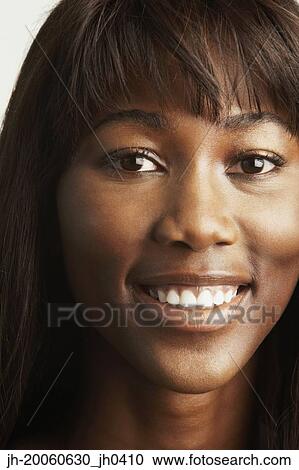 Stock Image - Close up of African woman smiling. Fotosearch