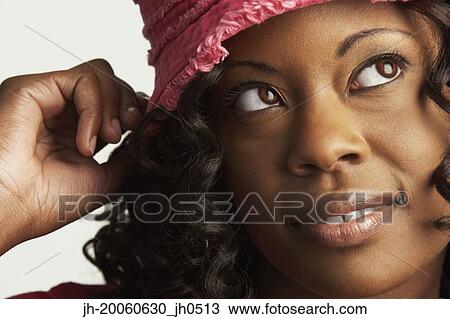 Close up of African woman wearing hat View Large Photo Image Stock Image - Close up of African woman wearing hat. Fotosearch