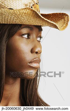 Close up of African woman wearing straw hat View Large Photo Image Stock Photo - Close up of African woman wearing straw hat. Fotosearch