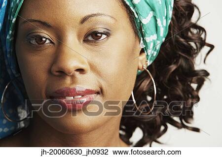 Close up of African woman with hair wrap View Large Photo Image Stock Image - Close up of African woman with hair wrap. Fotosearch