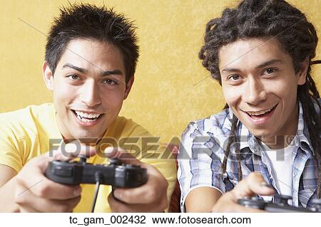 Close up of two young men playing video games View Large Photo Image Stock Image - Close up of two young men playing video games. Fotosearch