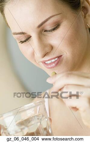 Close up of woman taking vitamin View Large Photo Image Picture - Close up of woman taking vitamin. Fotosearch