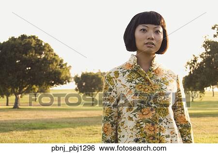 Stock Photograph - Close up of young Asian woman outdoors. Fotosearch