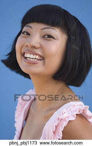 Stock Image - Close up of young Asian woman smiling. Fotosearch