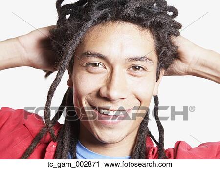 Stock Image - Close up of young Hispanic man smiling. Fotosearch