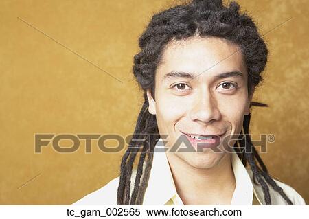 Close up of young Hispanic man smiling indoors View Large Photo Image Stock Photography - Close up of young Hispanic man smiling indoors. Fotosearch