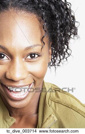 Picture - Close up studio shot of African woman smiling. Fotosearch