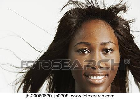 Close up studio shot of African woman with hair blowing View Large Photo Image Stock Photo - Close up studio shot of African woman with hair blowing. Fotosearch
