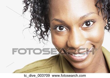 Stock Photo - Close up studio shot of African woman smiling. Fotosearch