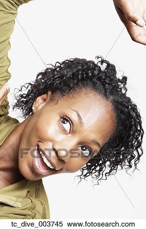 Stock Photography - Close up studio shot of African woman smiling. Fotosearch