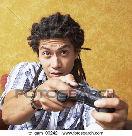 Close up young man playing video games View Large Photo Image Stock Image - Close up young man playing video games. Fotosearch