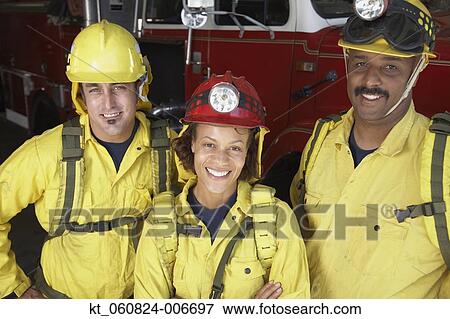 Firefighters smiling next to fire truck View Large Photo Image Stock Photo - Firefighters smiling next to fire truck. Fotosearch
