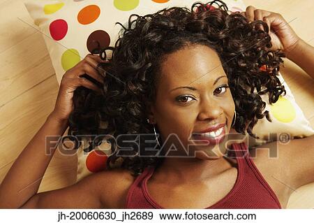 High angle view of African woman laying on floor smiling View Large Photo Image Stock Photo - High angle view of African woman laying on floor smiling. Fotosearch