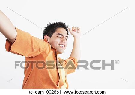 Low angle studio shot of young man dancing View Large Photo Image Stock Image - Low angle studio shot of young man dancing. Fotosearch