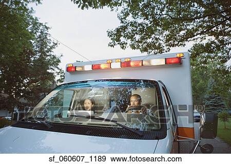Male and female paramedics in cab of ambulance View Large Photo Image Stock Photo - Male and female paramedics in cab of ambulance. Fotosearch