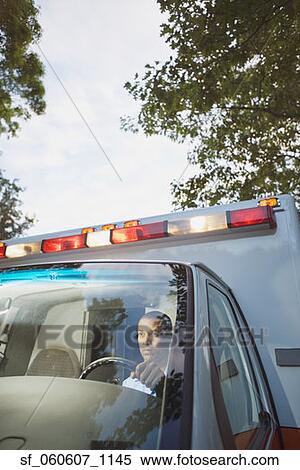 Male paramedic driving ambulance View Large Photo Image Stock Photography - Male paramedic driving ambulance . Fotosearch