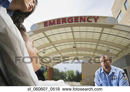 Stock Photo - Paramedics and patient in front of hospital. Fotosearch
