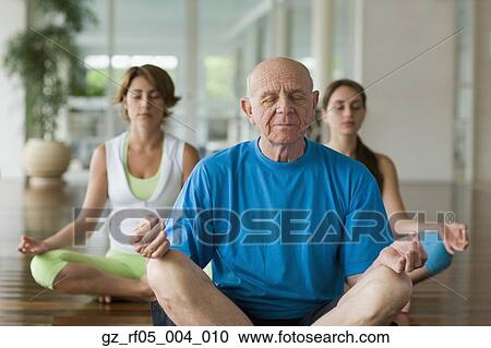 Senior man and two women meditating indoors View Large Photo Image Stock Image - Senior man and two women meditating indoors. Fotosearch