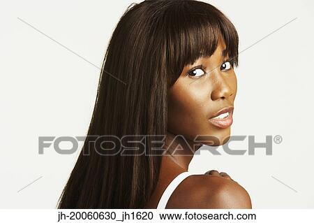 Studio shot of African woman looking over shoulder View Large Photo Image Stock Image - Studio shot of African woman looking over shoulder. Fotosearch