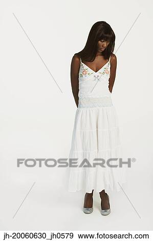 Stock Photo - Studio shot of African woman looking down. Fotosearch