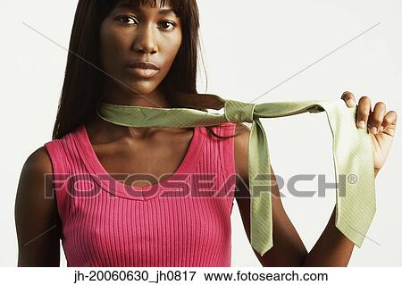 Studio shot of African woman pulling on necktie View Large Photo Image Stock Photo - Studio shot of African woman pulling on necktie. Fotosearch