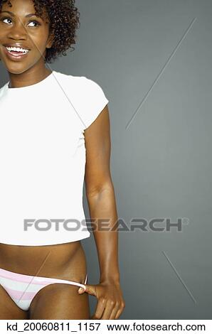 Studio shot of African woman smiling in tee shirt and underwear View Large Photo Image Stock Photo - Studio shot of African woman smiling in tee shirt and underwear. Fotosearch