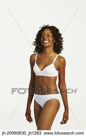 Stock Image - Studio shot of African woman wearing underwear and smiling. Fotosearch