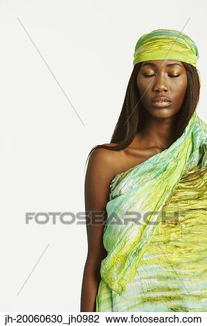 Stock Image - Studio shot of African woman with eyes closed. Fotosearch