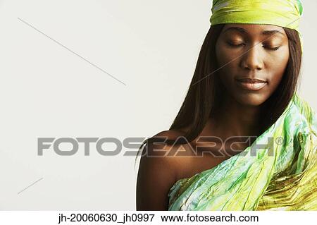 Stock Photo - Studio shot of African woman with eyes closed. Fotosearch