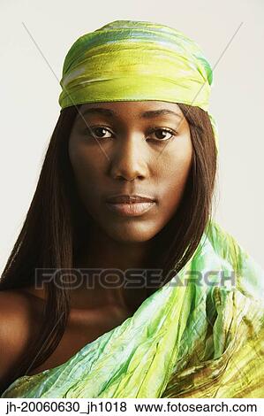 Stock Photo - Studio shot of African woman with scarf around head. Fotosearch