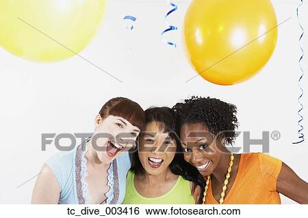 Stock Photograph - Studio shot of three women smiling with balloons. Fotosearch