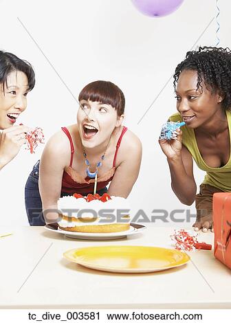 Studio shot of three women with cake and noise makers View Large Photo Image Stock Image - Studio shot of three women with cake and noise makers. Fotosearch