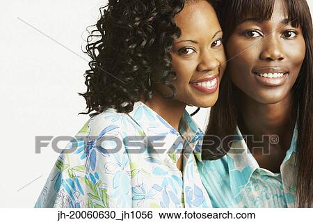 Studio shot of two African women smiling View Large Photo Image Stock Photograph - Studio shot of two African women smiling. Fotosearch
