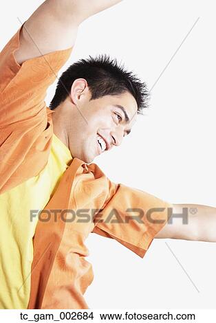 Picture - Studio shot of young man dancing. Fotosearch