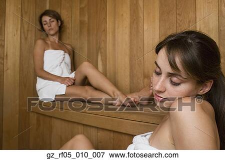 Two women in towels sitting in sauna View Large Photo Image Stock Photo - Two women in towels sitting in sauna. Fotosearch