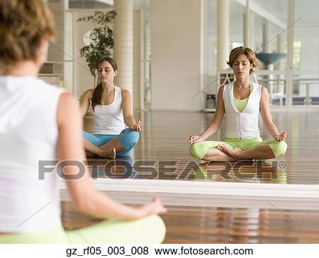 Two women meditating in front of mirror View Large Photo Image Stock Photo - Two women meditating in front of mirror. Fotosearch