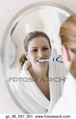 Woman in bathrobe brushing teeth View Large Photo Image Stock Image - Woman in bathrobe brushing teeth. Fotosearch
