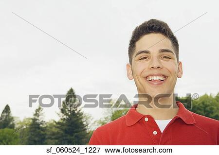 Young man smiling outdoors View Large Photo Image Stock Photo - Young man smiling outdoors. Fotosearch