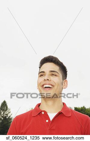 Stock Photography - Young man smiling outdoors. Fotosearch