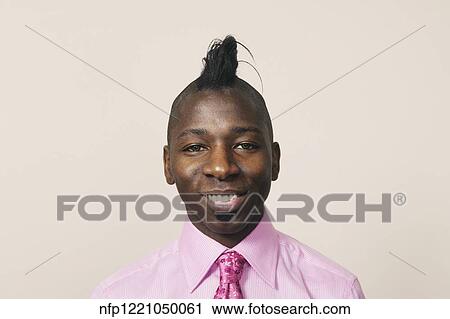 Stock Image - African businessman with mohawk hairstyle. Fotosearch