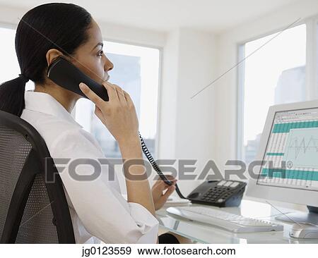 African businesswoman talking on telephone View Large Photo Image Stock Photo - African businesswoman talking on telephone. Fotosearch