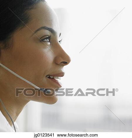 Stock Image - African businesswoman wearing headset. Fotosearch