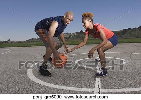 African man and woman playing basketball View Large Photo Image Stock Image - African man and woman playing basketball. Fotosearch