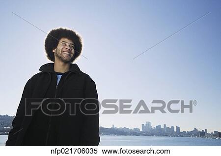 Stock Photography - African man in front of city skyline. Fotosearch